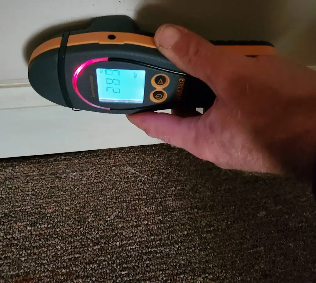 Moisture detection at baseboard during Storm Damage Restoration in South Windsor